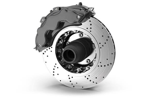 The Mufflerman, Mechanic Near Me A high-performance car brake disc and caliper on a black background. The metallic disc features drilled holes, while the dark caliper covers part of it, emphasizing precision—a testament to top-tier vehicle service.